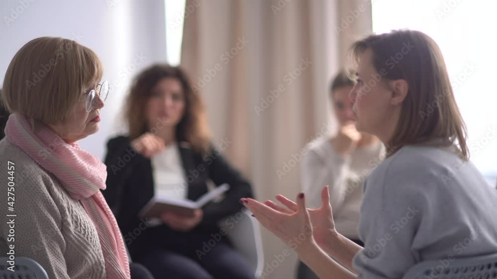 Portrait of a crying emotional woman telling her story at a psychotherapy group. Psychological meeting, group therapy Portrait of a crying emotional woman telling her story at a psychotherapy group. Psychological meeting, group therapy
