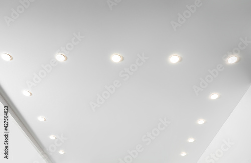 White ceiling with spot lamps in room, low angle view