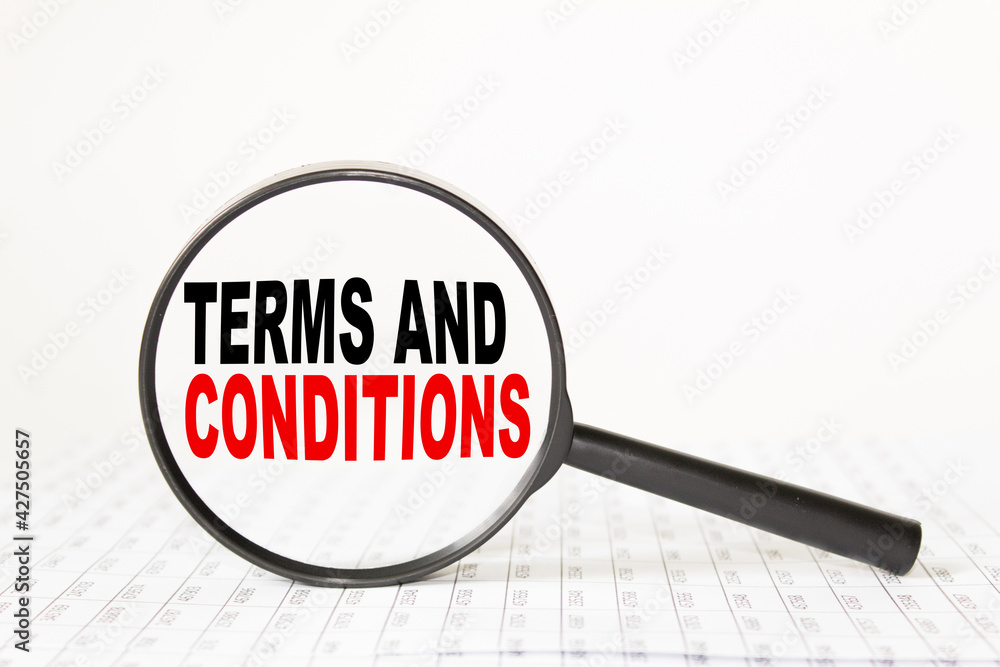 words TERMS AND CONDITIONS in a magnifying glass on a white background. business concept words TERMS AND CONDITIONS in a magnifying glass on a white background. business concept