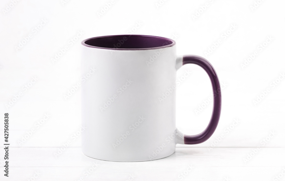 White ceramic cup colored violet inside White ceramic cup colored violet inside