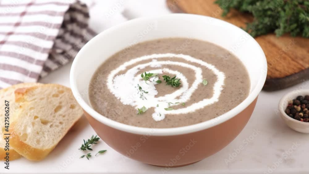 Garnish mushroom cream soup with herbs. Healthy blended mushroom cream soup in a bowl Garnish mushroom cream soup with herbs. Healthy blended mushroom cream soup in a bowl