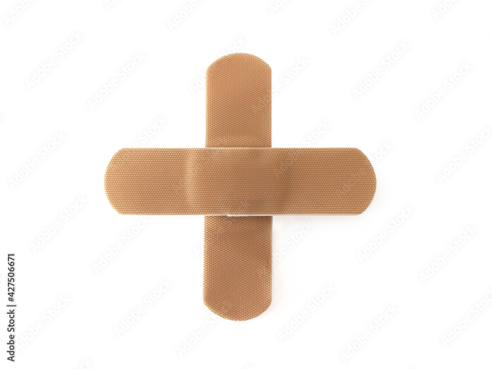 Aerial view of Cross bandaid isolated on white background. Protective tape strip, wound patch close up. First aid adhesive plaster First aid and sanitary equipment concept. Aerial view of Cross bandaid isolated on white background. Protective tape strip, wound patch close up. First aid adhesive plaster First aid and sanitary equipment concept.