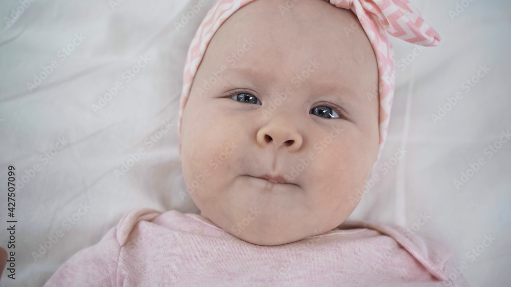 top view of adorable baby looking at camera. top view of adorable baby looking at camera.
