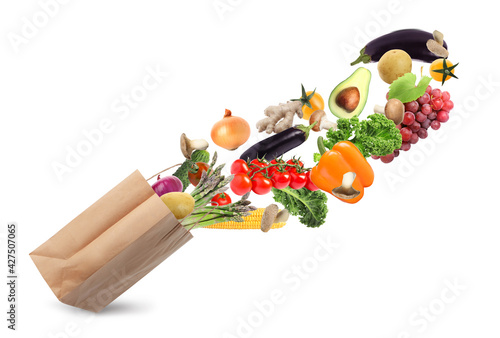 Fototapeta Naklejka Na Ścianę i Meble -  Paper bag with vegetables and fruits on white background. Vegetarian food