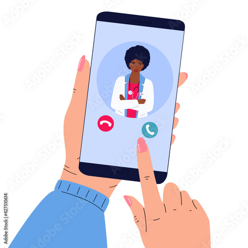 The patient makes a video call to the doctor online. Hands holding smartphone. Telemedicine concept. African American women medical worker advises a sick person remotely.