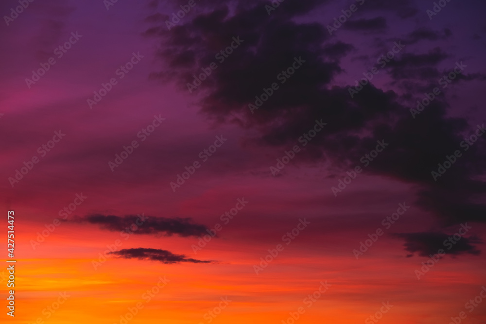 Bright colorful sunset sky with few clouds