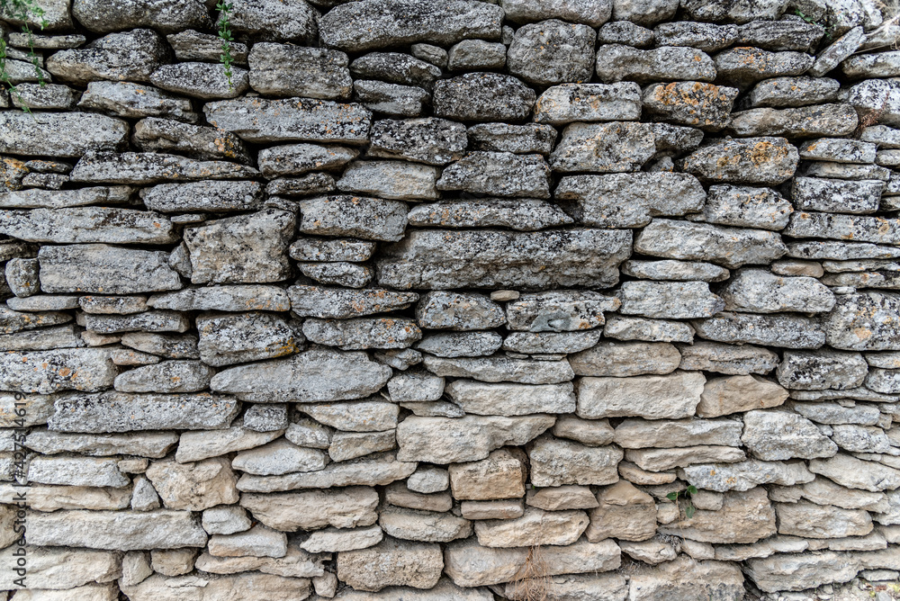 An ancient grey stone wall, texture, backdrop, stone blocks, background 