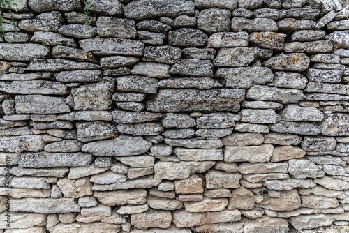 An ancient grey stone wall, texture, backdrop, stone blocks, background 