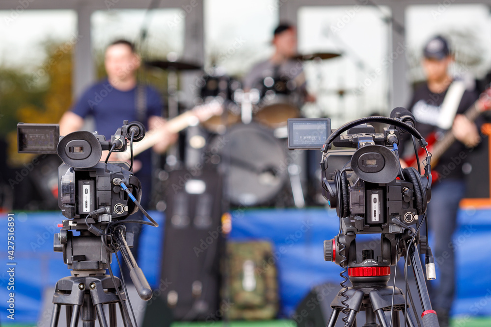 two cameras on tripods are installed during the concert two cameras on tripods are installed during the concert