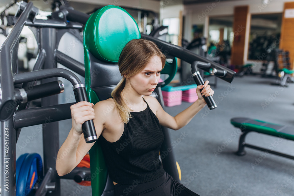 Girl doing exercise in the gym. Sport, healthy lifestyle concept Girl doing exercise in the gym. Sport, healthy lifestyle concept