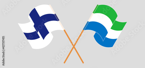 Crossed and waving flags of Finland and Sierra Leone