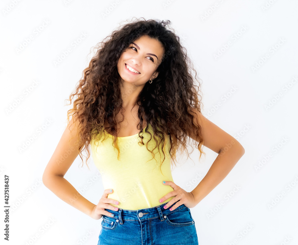 Beautiful smiling girl standing with hands on waist Beautiful smiling girl standing with hands on waist