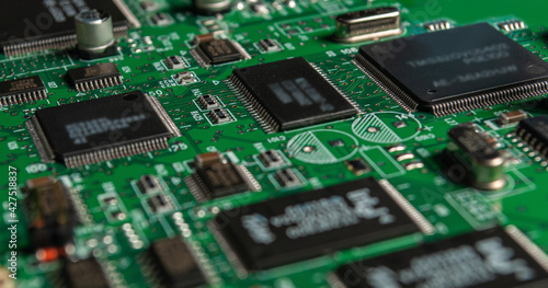 printed circuit board with surface mounted passive and active circuit components close up