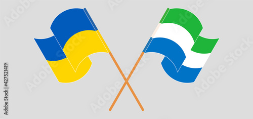 Crossed and waving flags of Ukraine and Sierra Leone
