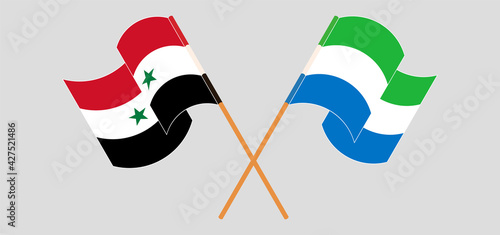 Crossed and waving flags of Syria and Sierra Leone