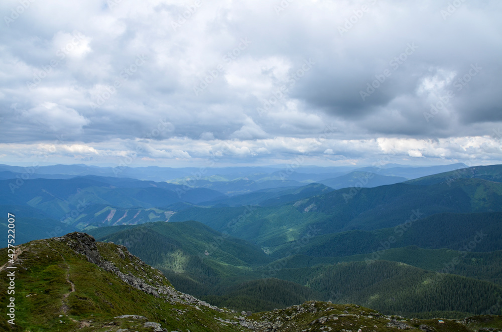 Beautiful view of mountains landscape with cloudy sky. Chornohora mountain ridge and beautiful cloudy sky from slopes of Pip Ivan mountain. Beautiful view of mountains landscape with cloudy sky. Chornohora mountain ridge and beautiful cloudy sky from slopes of Pip Ivan mountain.