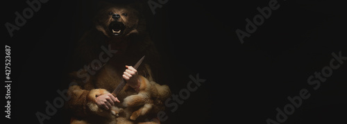 Panoramic Low key portrait of a bearded war shaman in bearskin with an ancient ax in his hands. High quality cosplay of the ancient werewolf war
