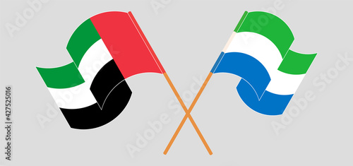Crossed and waving flags of the United Arab Emirates and Sierra Leone