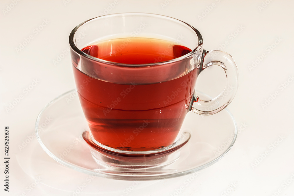 It is tea time. A transparent cup of black tea or rooibos tea white background. Closeup. Tea background. Stock photo, copy space It is tea time. A transparent cup of black tea or rooibos tea white background. Closeup. Tea background. Stock photo, copy space