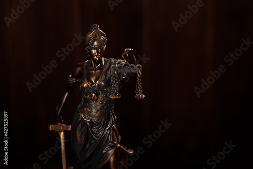 Lady of justice in wooden courtroom
