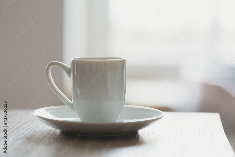 White cup of morning coffee on the table White cup of morning coffee on the table