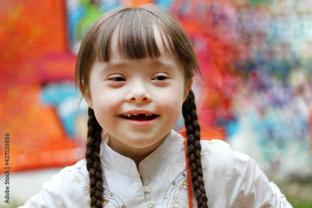 Portrait of little girl smiling on background of the colorful wall Portrait of little girl smiling on background of the colorful wall