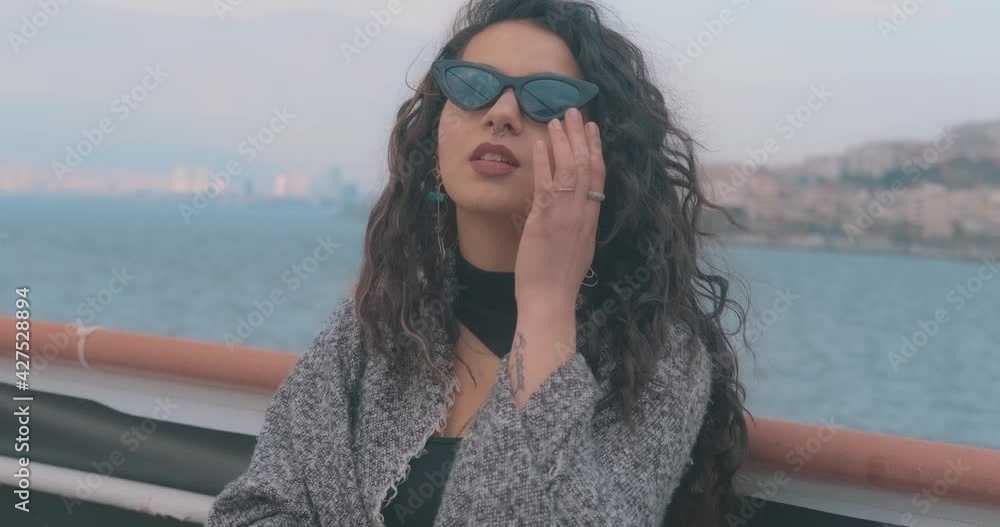 Young 20's student woman is smiling to camera with sunglasses. Positive face, cheerful and happy lady. Young 20's student woman is smiling to camera with sunglasses. Positive face, cheerful and happy lady.