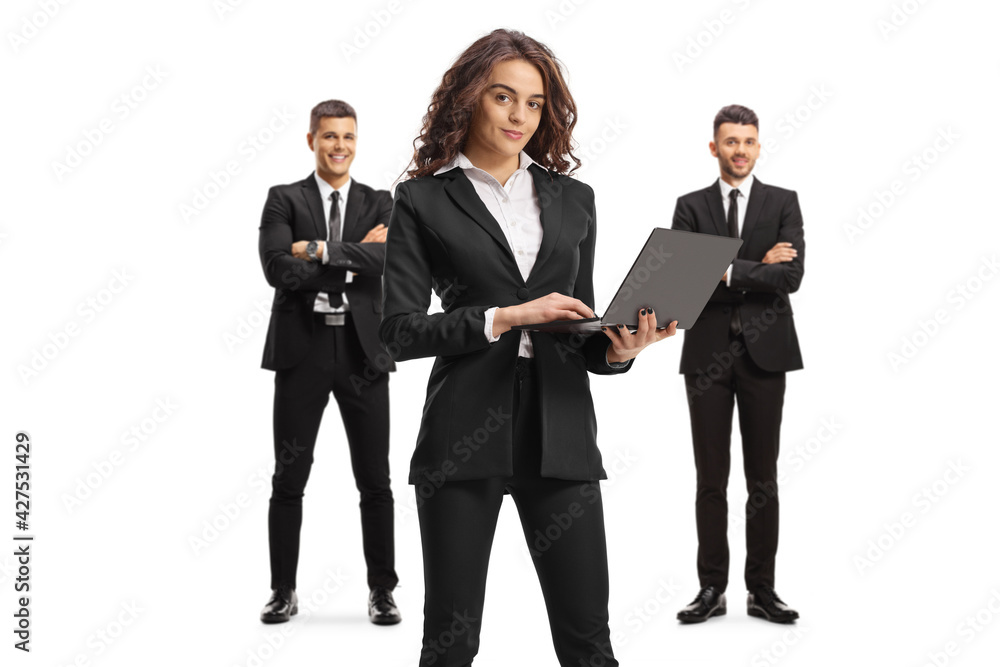 Businesswoman with a laptop and two professional men standing behind Businesswoman with a laptop and two professional men standing behind
