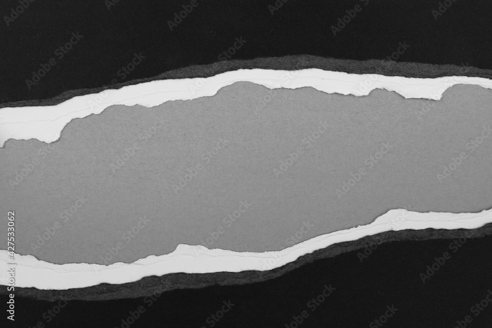 Ripped paper on grey Ripped paper on grey