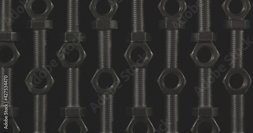 metal nuts and bolts on a black background