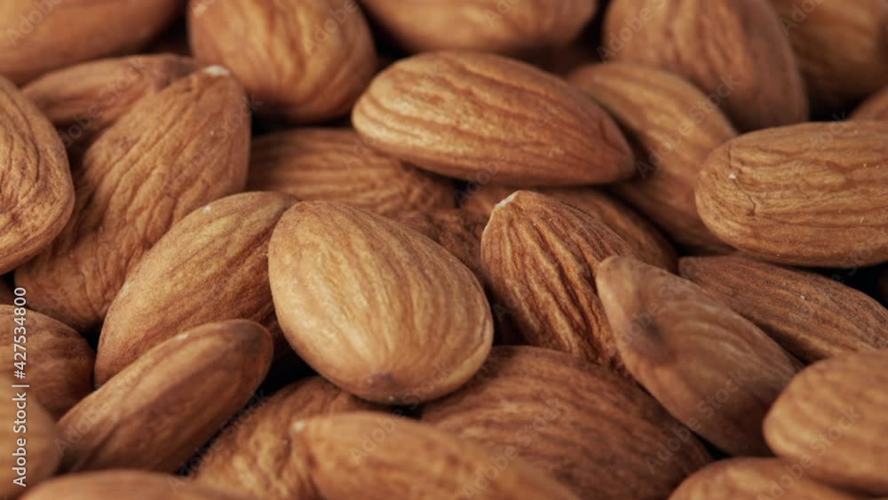 Nut almond close up. Product rich in minerals and vitamins. Almond turns in a shot. Almond kernels rotating. Close up food background. Nut almond close up. Product rich in minerals and vitamins. Almond turns in a shot. Almond kernels rotating. Close up food background.