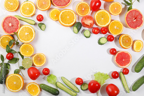 Fresh summer tropical fruits and vegetables on a bright sunny table with place for text  detox diet and weight loss concept. Top view  healthy and natural food  source of vitamin C  selective focus