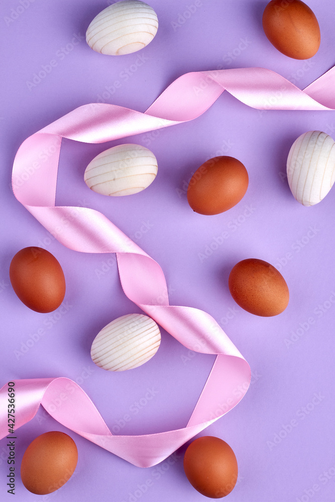 Composition of chicken eggs and pink tape.
