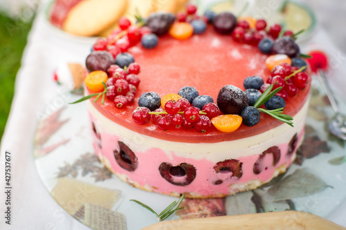 Cheesecake with berries on the picnik in the park.W eading cake on table in the park photo