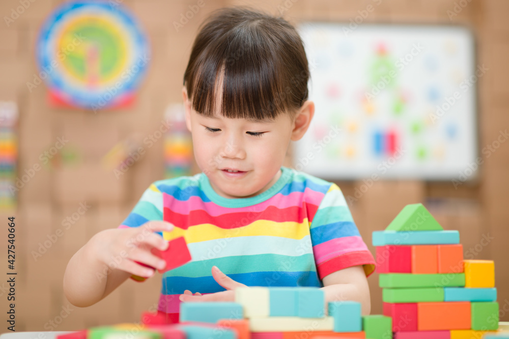 young girl playing creative toy blocks for homeschooling young girl playing creative toy blocks for homeschooling