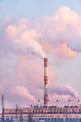 Industrial factory pipes emission carbon gases in atmosphere. Industry zone emission, Factory with thick smoke plumes. Climate change, ecology and global warming. Vertical photo