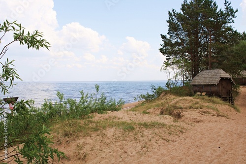Fototapeta Naklejka Na Ścianę i Meble -  Small huts for relaxation on the sandy shore of the Gulf of Riga in Latvia June 7, 2019