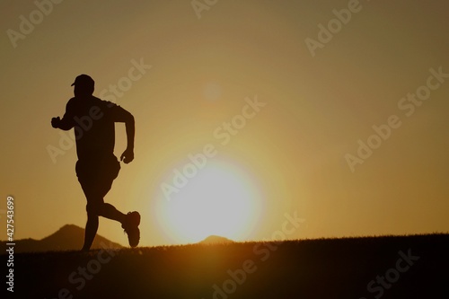 Silhouette of a male runner at sunset