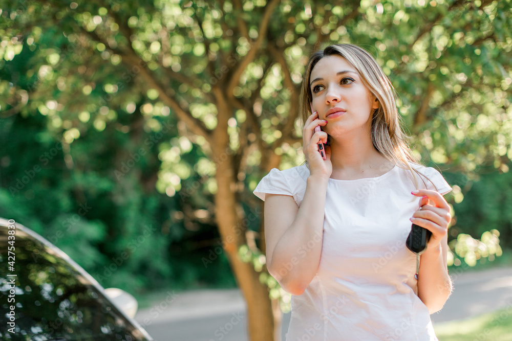 Fashionable blond pretty woman with smart phone and car keys,outdoor. Fashionable blond pretty woman with smart phone and car keys,outdoor.