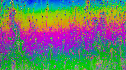 Fluid soap bubble psychedelic colorful abstract art. Surreal patterns with rainbows and waves of color in motion.
