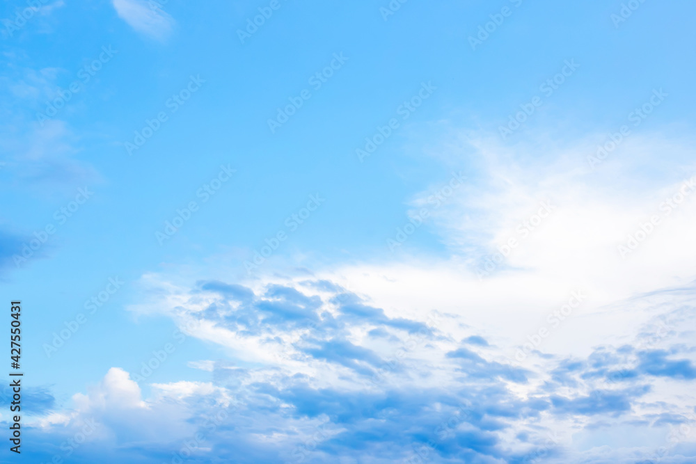 Blue clouds in sky during morning background. Clear skies with blue clouds at sunset above field. Open view out windows summer day.