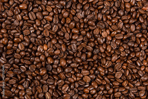 Freshly roasted coffee beans background. close up.