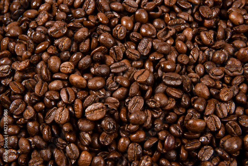 Freshly roasted coffee beans background. close up.