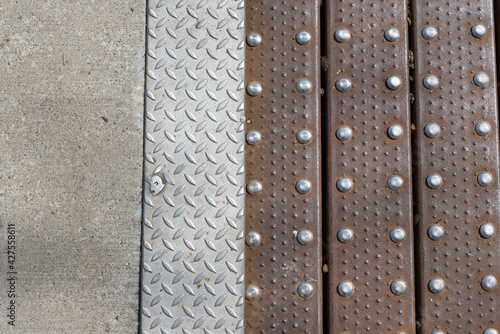 concrete, anti-slip steel plate, and rusty slats fastened with stainless steel rivets