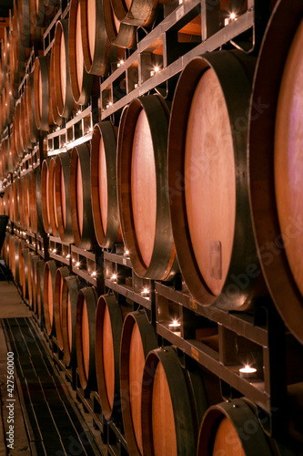 фотографія Wall of wooden wine barrels stacked over each other