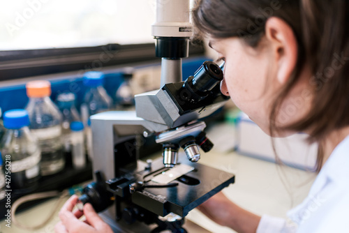 Female Scientist Using Microscopy in Laboratory