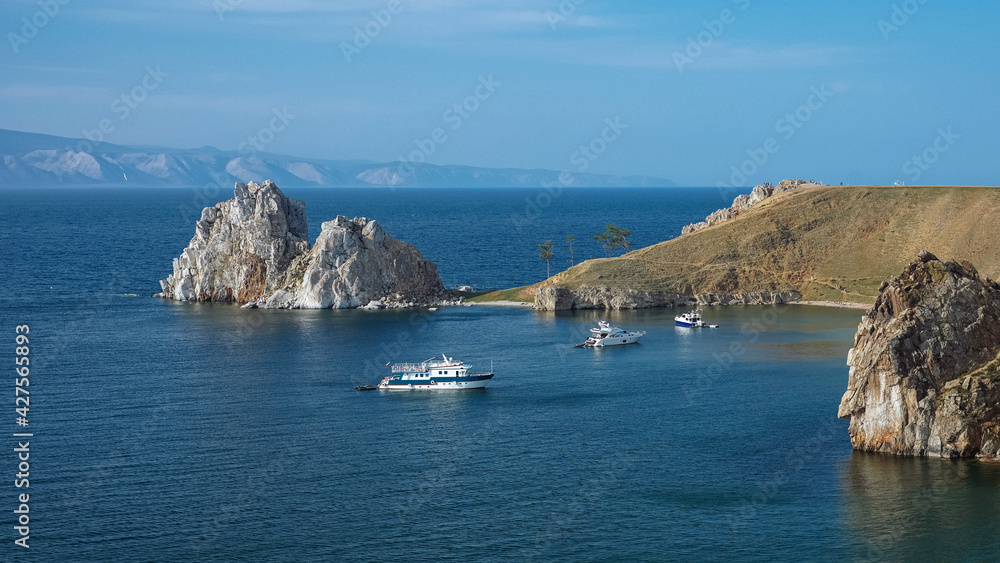 Rocky bay with clear blue water and yachts. Stone island. Beautiful European view. Unique nature of Olchon island