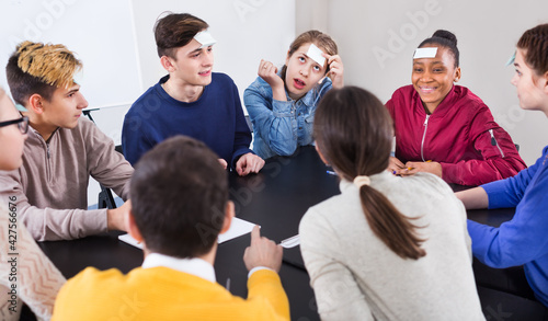 Fellow students playing the guess-who game during a school day