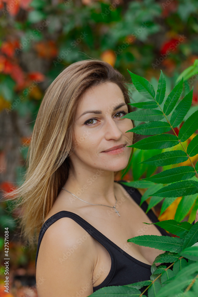 Beautiful portrait of a young woman in autumn bushes. Beautiful portrait of a young woman in autumn bushes.
