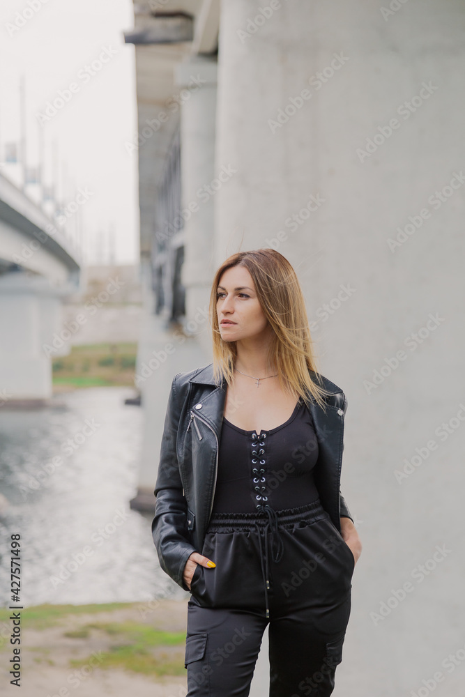 Beautiful young woman at the concrete bridge.